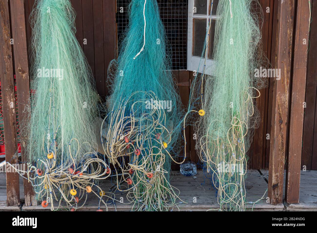 Fishing net hanging on wooden hi-res stock photography and images
