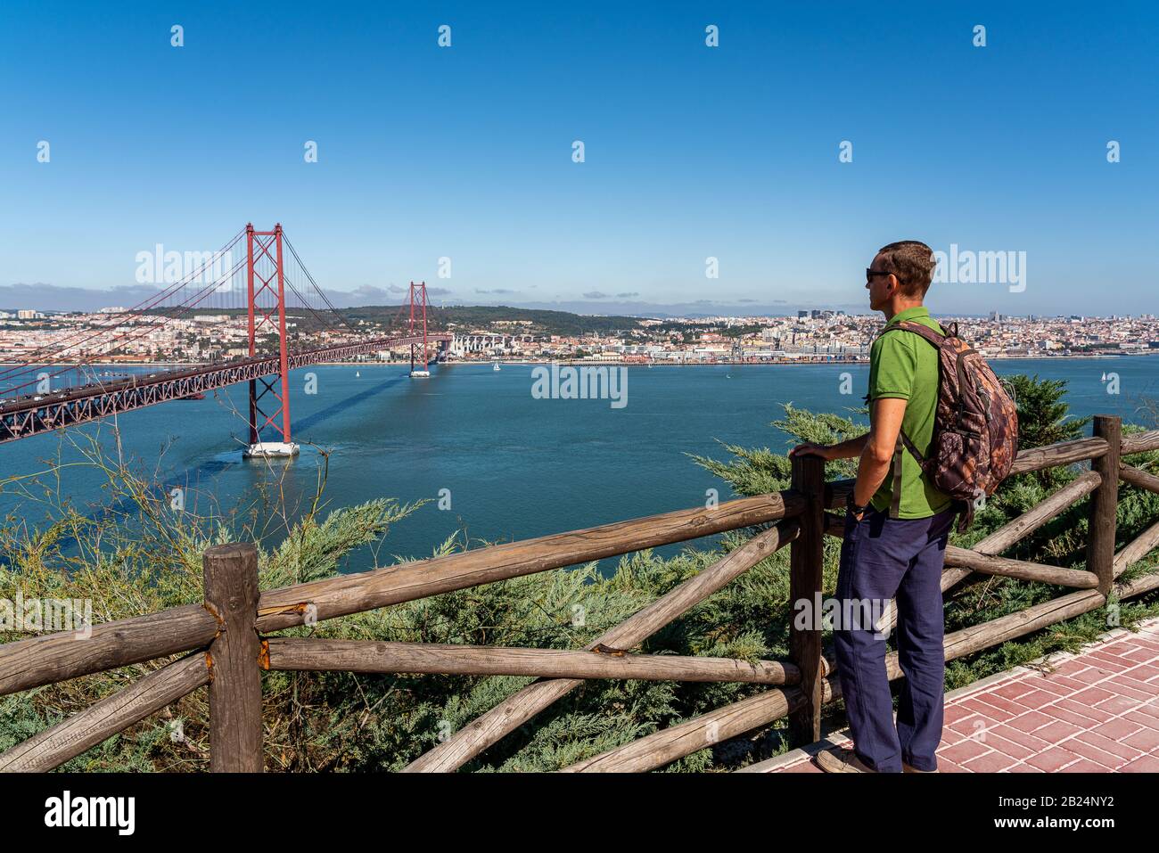 A male tourist contemplates a view of the bridge on April 25 in Lisbon Stock Photo