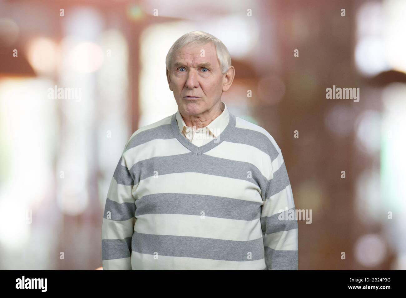 Dissatisfied old grandfather. Stock Photo
