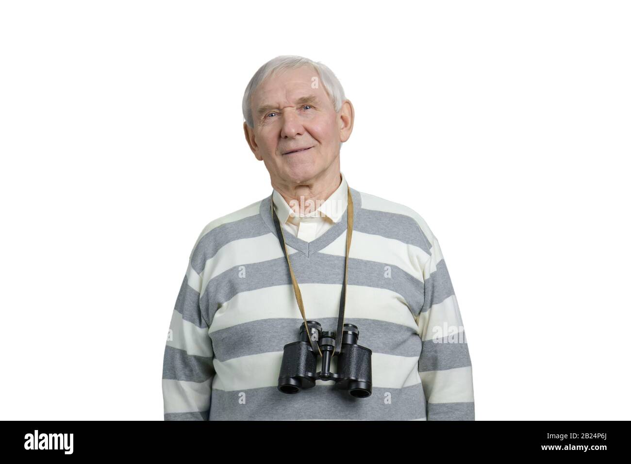 Happy senior man with binoculars round his neck. Stock Photo