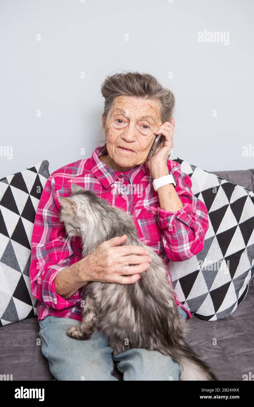 Theme old person uses technology. Mature contented joy smile active