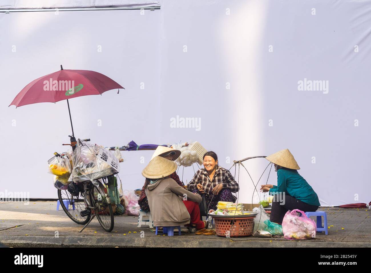 Saigon (Ho Chi Minh City) - Group of Vietnamese women selling fresh produce, chatting on the street of Saigon, Vietnam, Southeast Asia. Stock Photo
