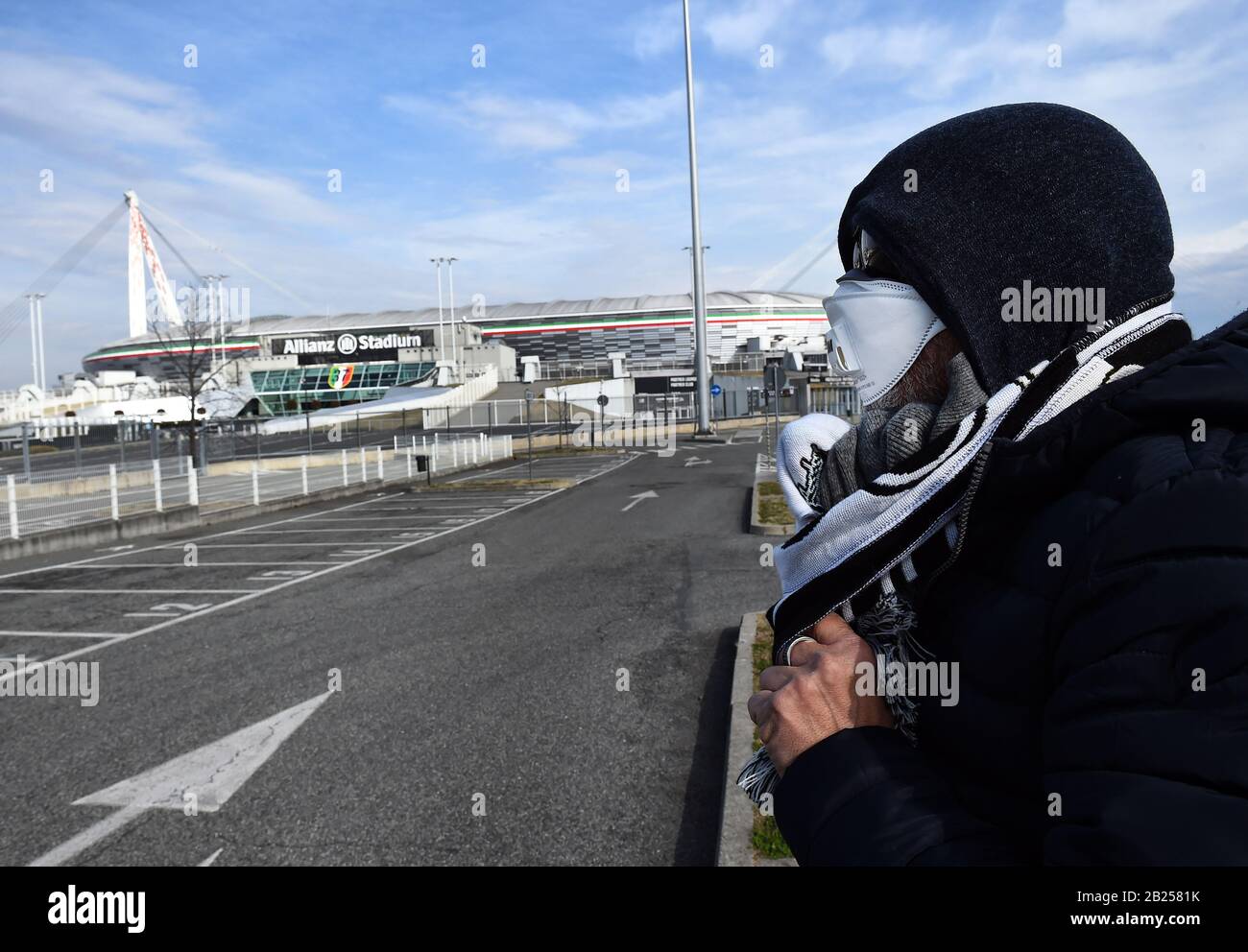 Rome, Italy. 29th Feb, 2020. A man wearing a face mask is seen outside the Allianz Stadium, after five Serie A matches were postponed because of the ongoing coronavirus epidemic, in Turin, Italy, Feb. 29, 2020. A total of 1,049 people tested positive for the novel coronavirus in Italy, Civil Protection Department chief and Extraordinary Commissioner for the coronavirus emergency Angelo Borrelli said on Saturday. Credit: Federico Tardito/Xinhua/Alamy Live News Stock Photo