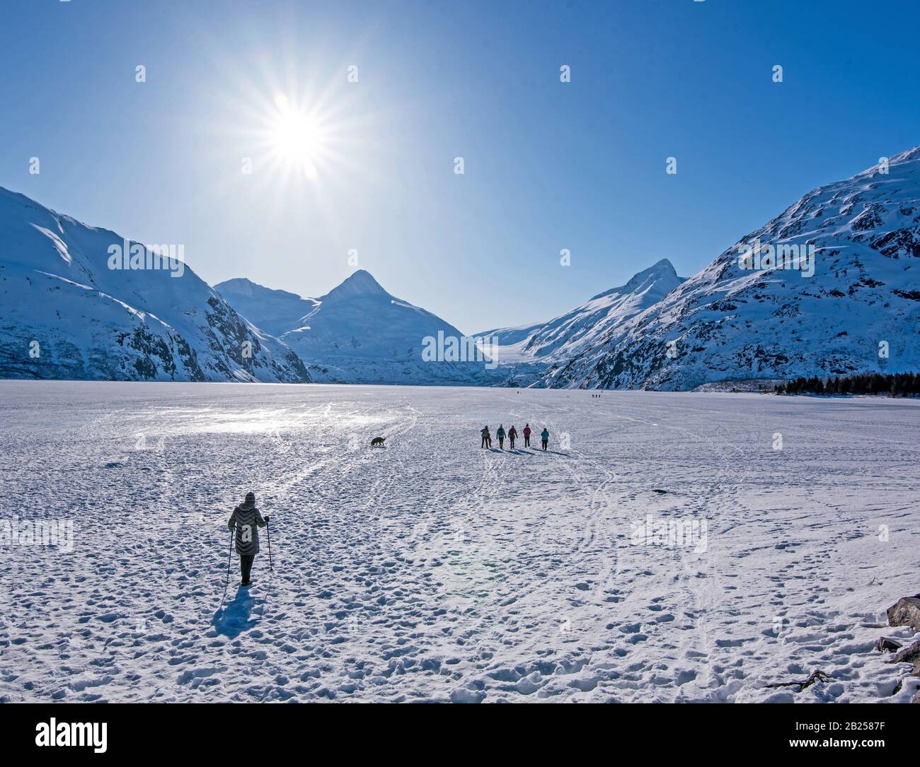 People walk across Portage Lake Stock Photo