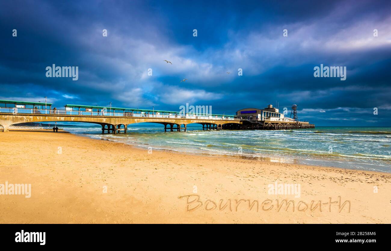 Colourful skies over Bournemouth Pier are reflected in the water Stock Photo