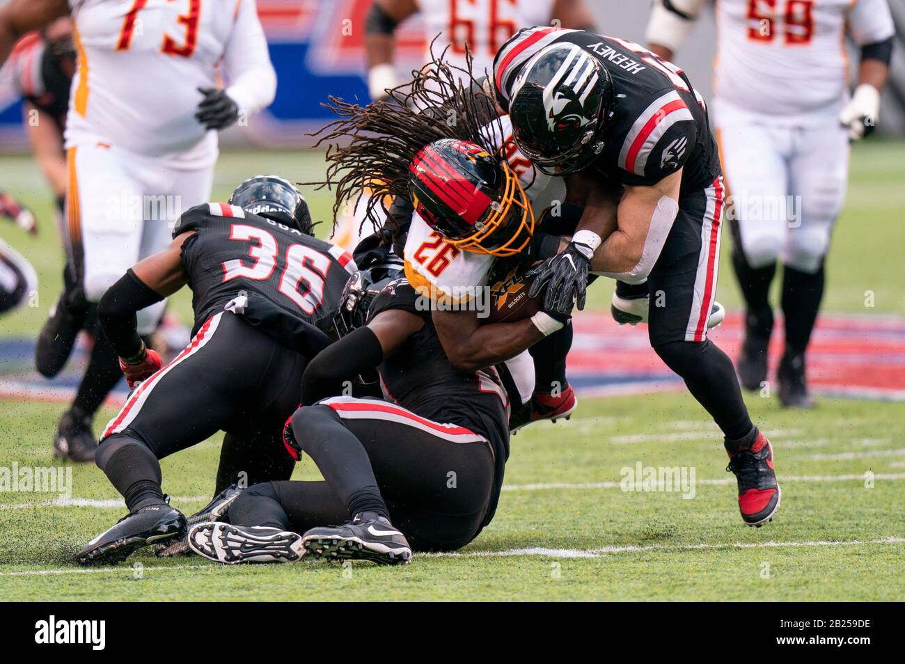 East Rutherford, New Jersey, USA. 29th Feb, 2020. Los Angeles Wildcats running back Harris DuJuan (26) gets tackled by New York Guardians linebacker Ben Heeney (56) and safety Andrew Soroh (30) during the XFL game at MetLife Stadium in East Rutherford, New Jersey. Guardians won 17-14. Christopher Szagola/CSM/Alamy Live News Stock Photo
