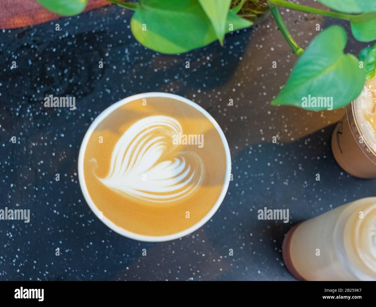 Latte art of latte coffee. Heart-shaped pull flower art Stock Photo - Alamy