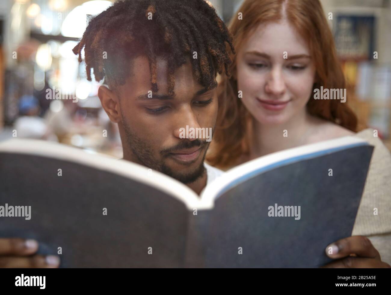 Millenials Reading a Book. Learning Concept. Stock Photo