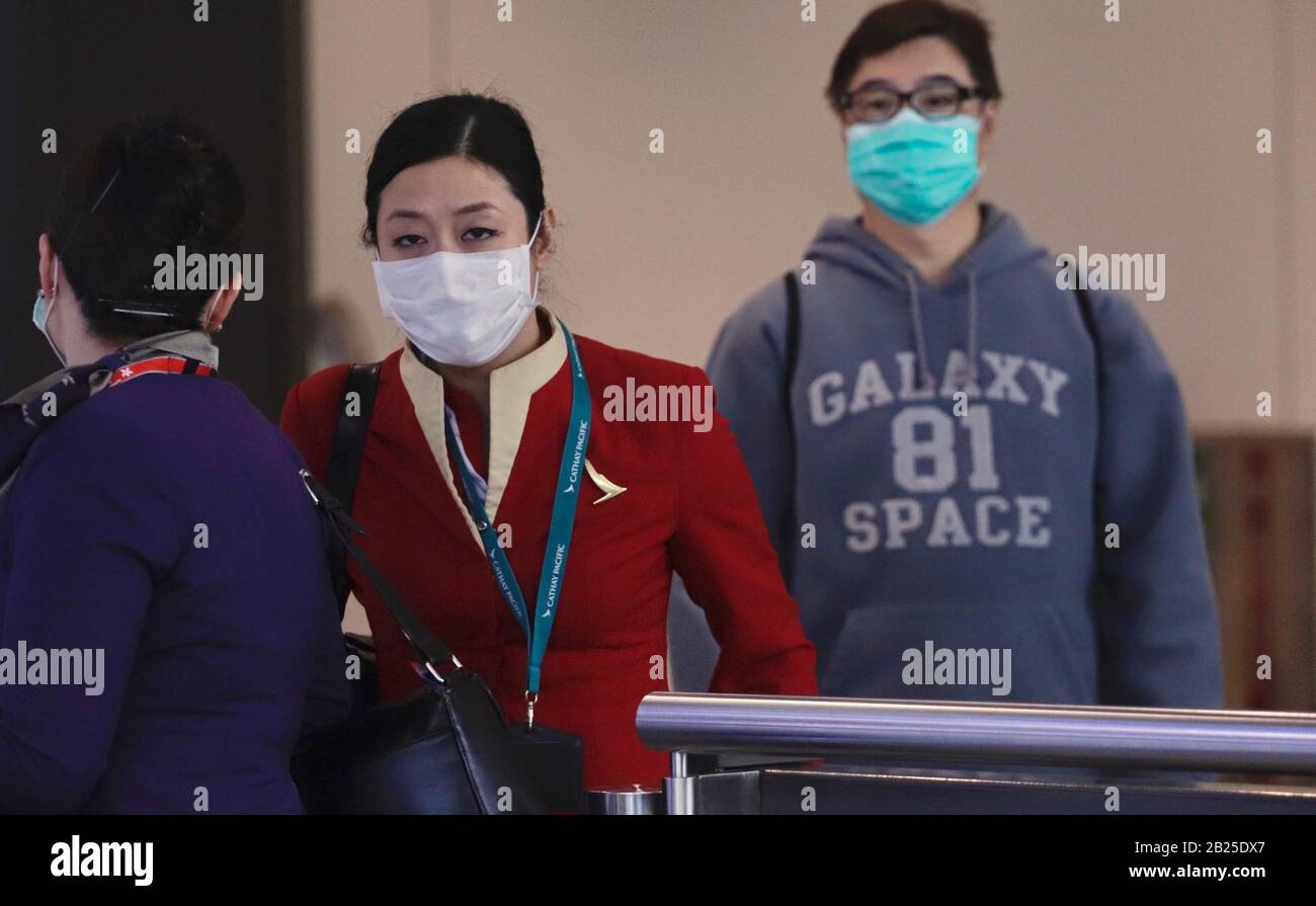Hong Kong, CHINA. 24th Feb, 2020. A masked Cathay Pacific cabin crew exit from the arriving hall at Hong Kong International Airport. Cathay Pacific Airways, a flagship airline of Hong Kong is struggling to ride out global Coronavirus outbreak by cutting flight schedules down to almost 50 percent this year.( File Photo ) Mar-1, 2020 Hong Kong.ZUMA/Liau Chung-ren Credit: Liau Chung-ren/ZUMA Wire/Alamy Live News Stock Photo