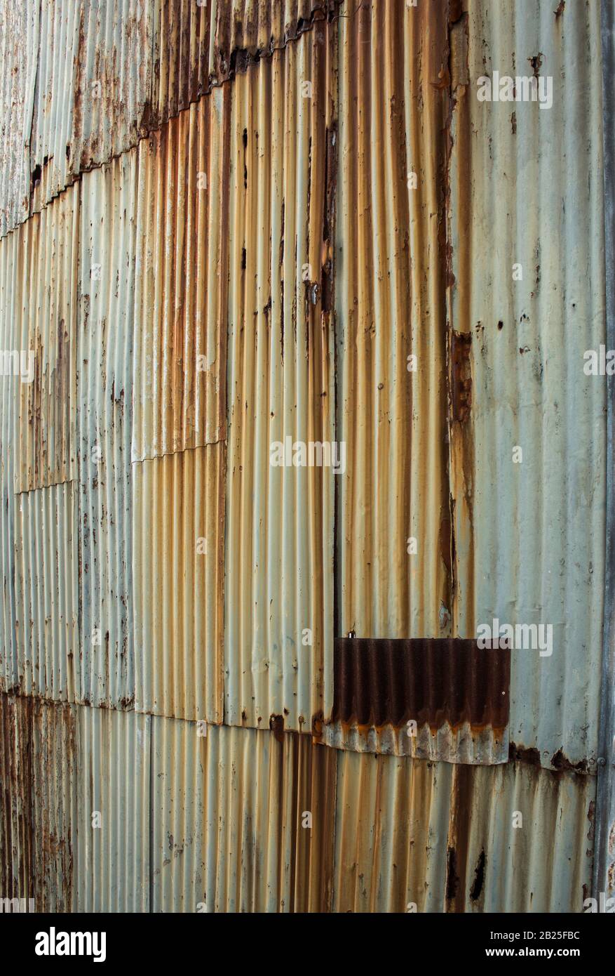 Rusting corrugated iron metal wall ideal as background wallpaper Stock Photo
