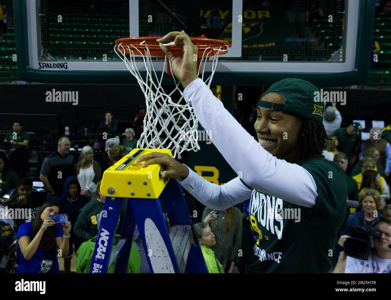 Waco, Texas, USA. 29th Feb, 2020. Baylor Lady Bears guard Juicy Landrum (20) cuts down the net after Baylor Lady Bears win the Big XII title after the NCAA Women's Basketball game between Kansas State and the Baylor Lady Bears at The Ferrell Center in Waco, Texas. Matthew Lynch/CSM/Alamy Live News Stock Photo