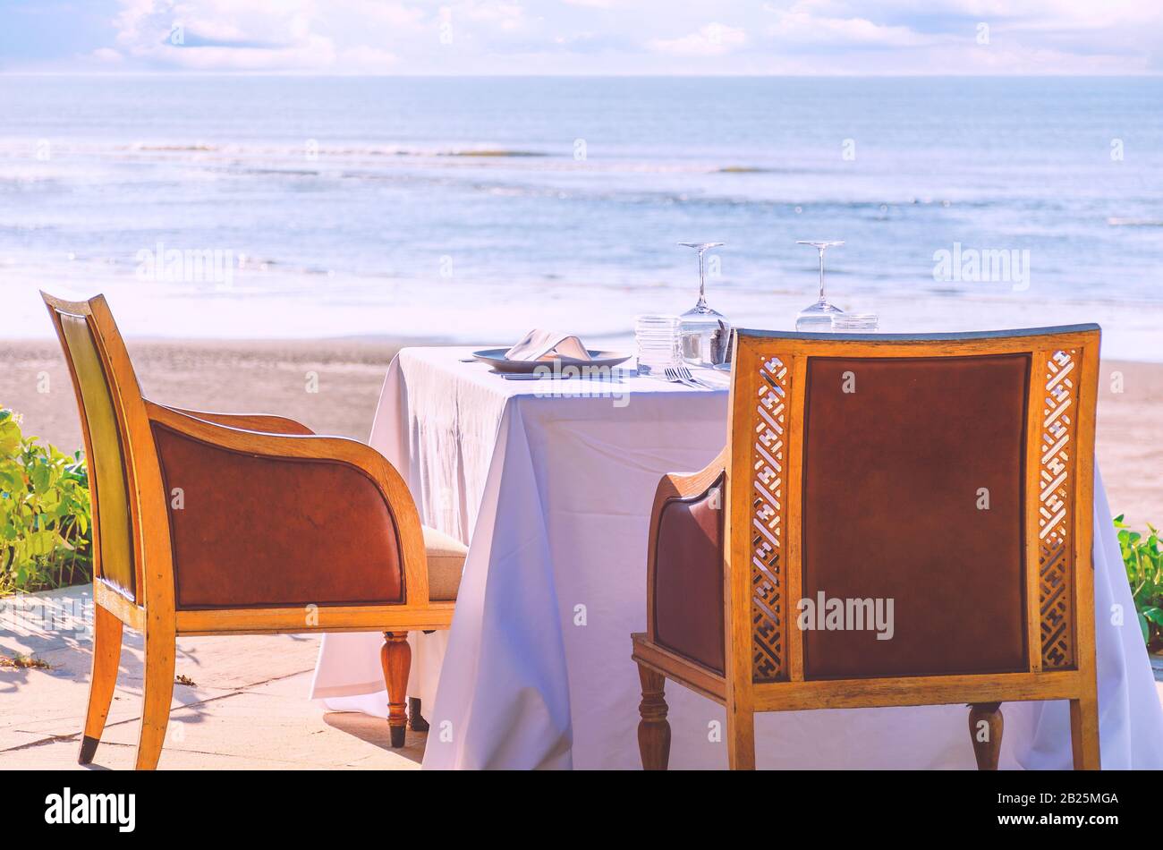 Table in a restaurant or resort by the sea beach served for two. Stock Photo
