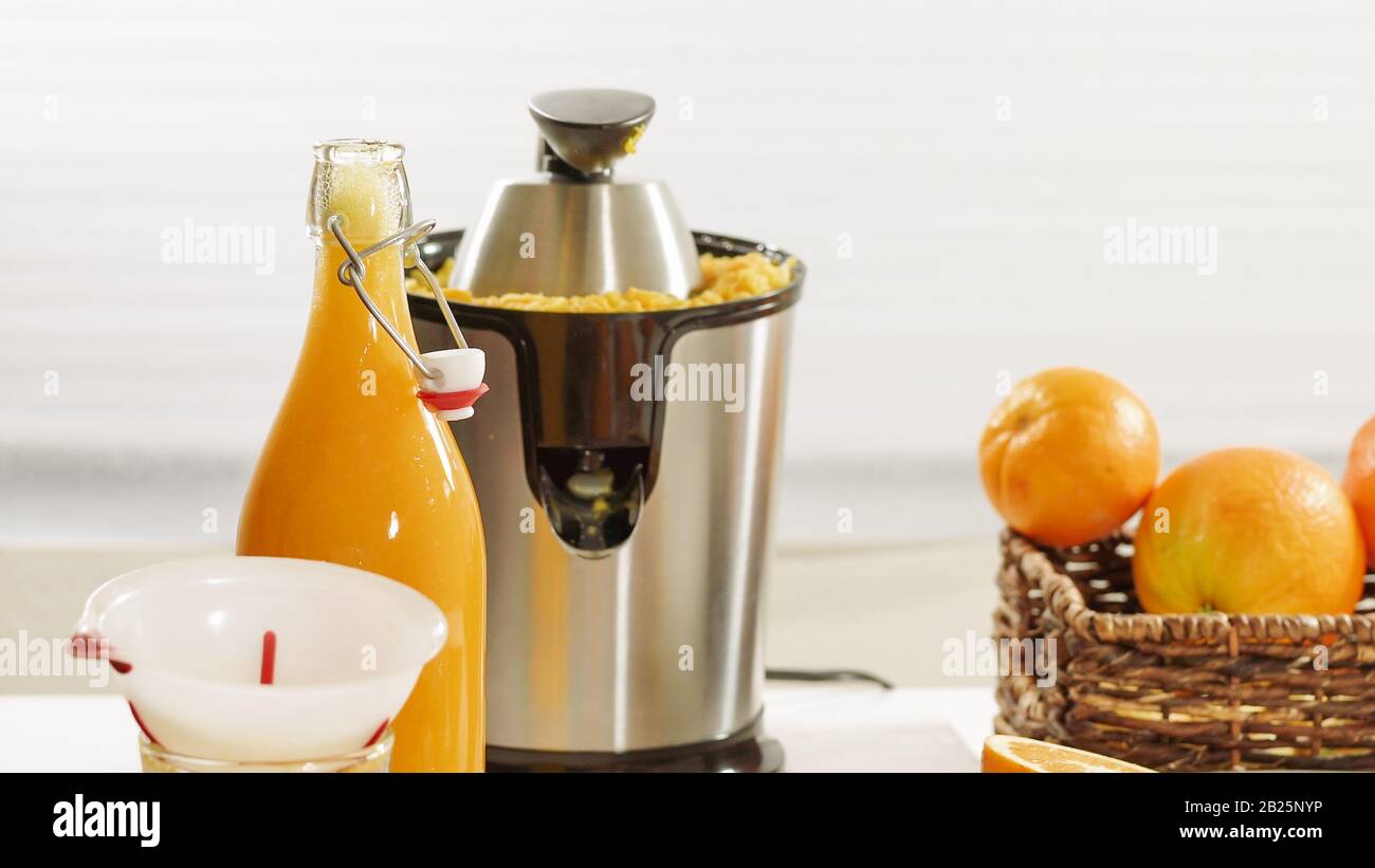 Freshly squeezed orange juice. Preparing fresh orange juice using an