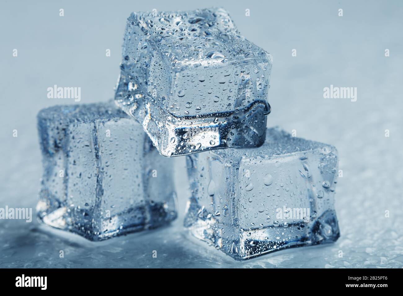 Ice cubes in the form of a pyramid with water drops close up in macro
