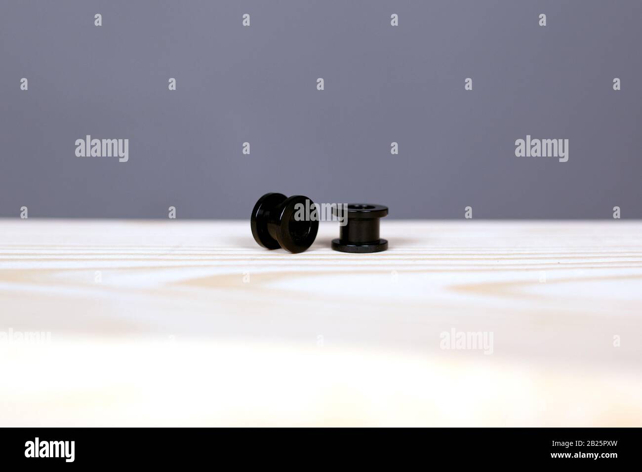 black piercing tunnels. ear piercing accessories closeup. Stock Photo
