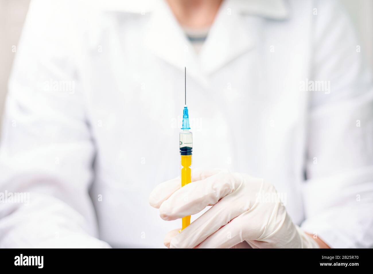 doctor holds a syringe with medicine. Concept: vaccine for influenza, coronavirus, hepatitis, AIDS. Stock Photo