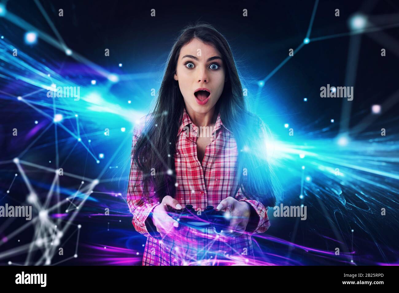 Shocked girl plays with online videogames. Concept of technology and entertainment Stock Photo