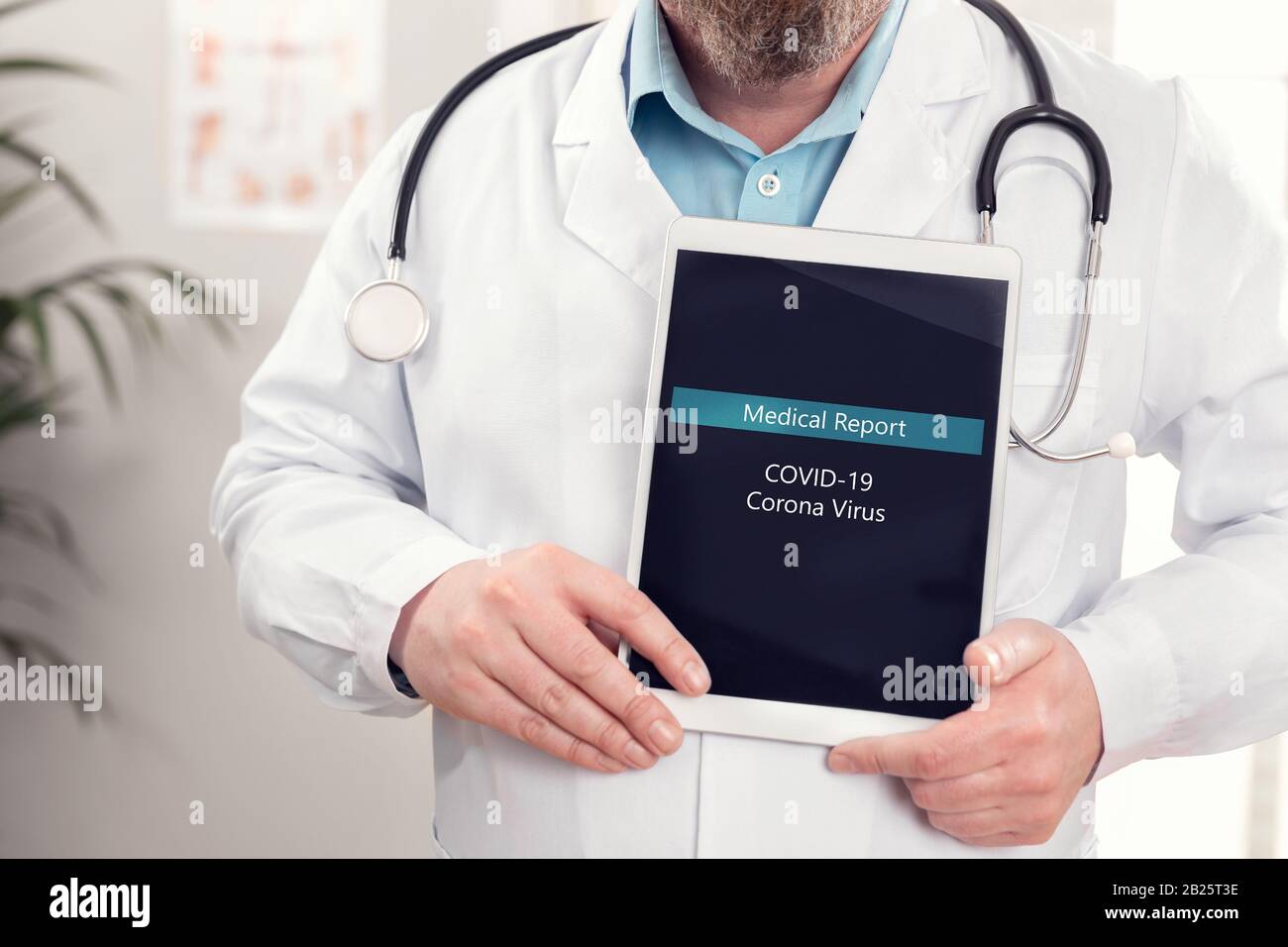 Male doctor showing medical covid-19 corona virus report on a tablet Stock Photo