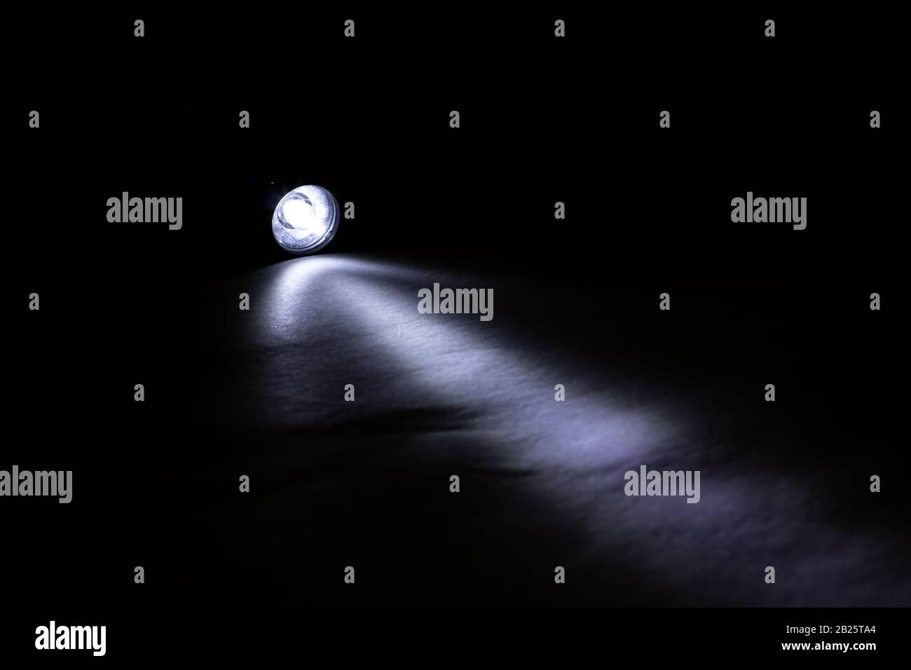 Blue light of a flashlight in the dark Stock Photo Alamy