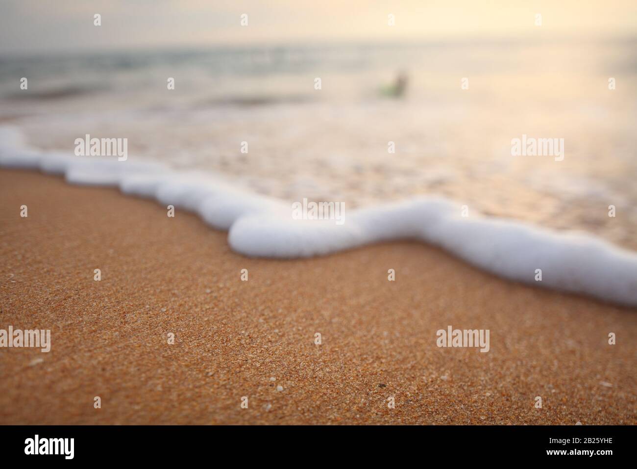 white foam on sandy tropical ocean beach Stock Photo - Alamy