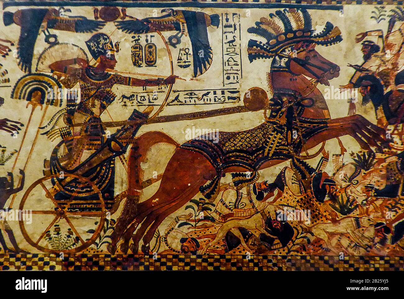 Egypt Cairo Archeological Museum Tutankhamun - Tutankhamun's War Chariot  Tutankhamun's painted chest features scenes of the king battling Egypts enemies, on the long sides he is shown as a warrior in his chariot attacking Libyans, Hittites and Nubians Stock Photo