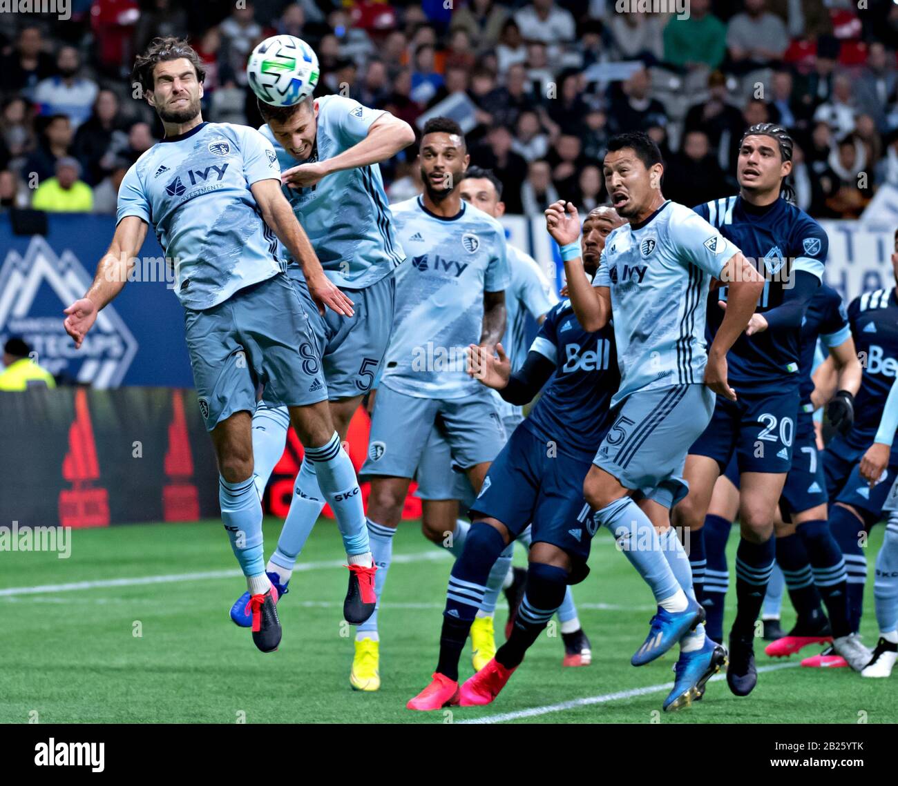 Vancouver, Canada. 29th Feb, 2020. Graham Zusi (1st L) of Sporting Kansas City heads the ball during a Major League Soccer regular season match between Sporting Kansas City and Vancouver Whitecups in Vancouver, Canada, on Feb. 29, 2020. Credit: Andrew Soong/Xinhua/Alamy Live News Stock Photo