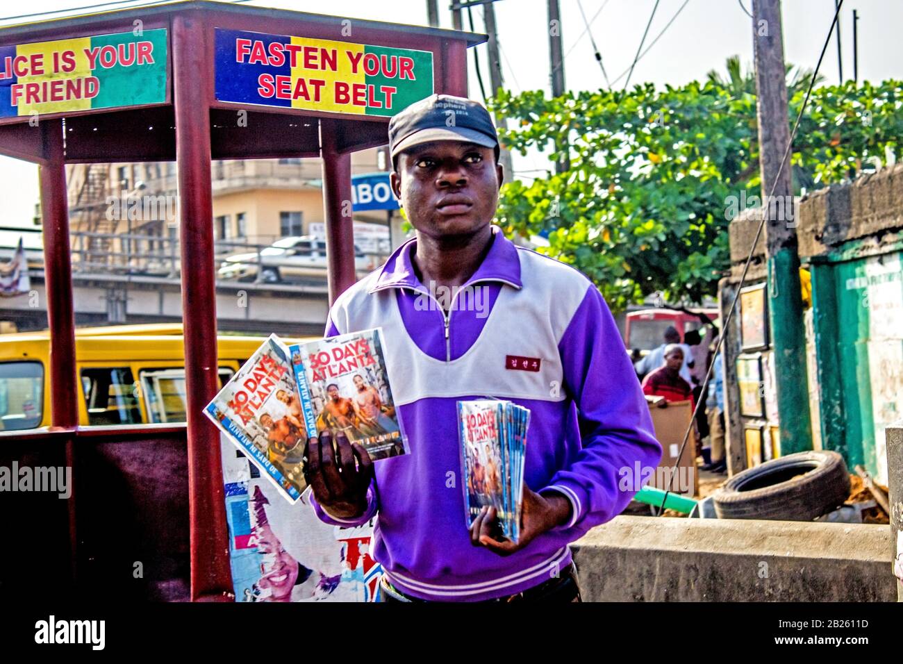 A man hawks bootleg DVDs on a street in Lagos, Nigeria. Stock Photo