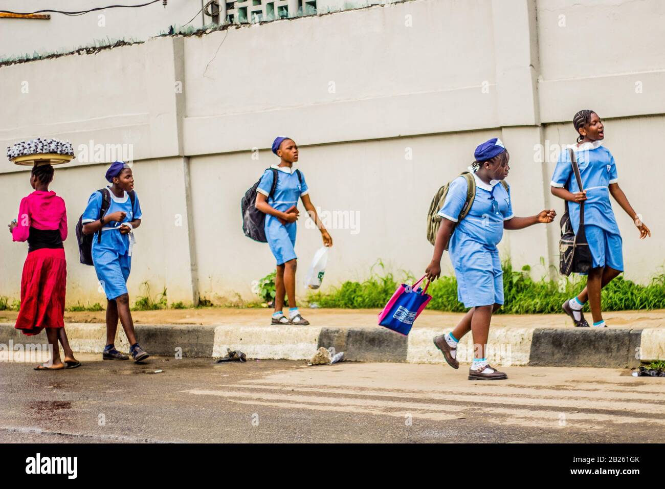 Students in school uniform walking on the street in Lagos, Nigeria