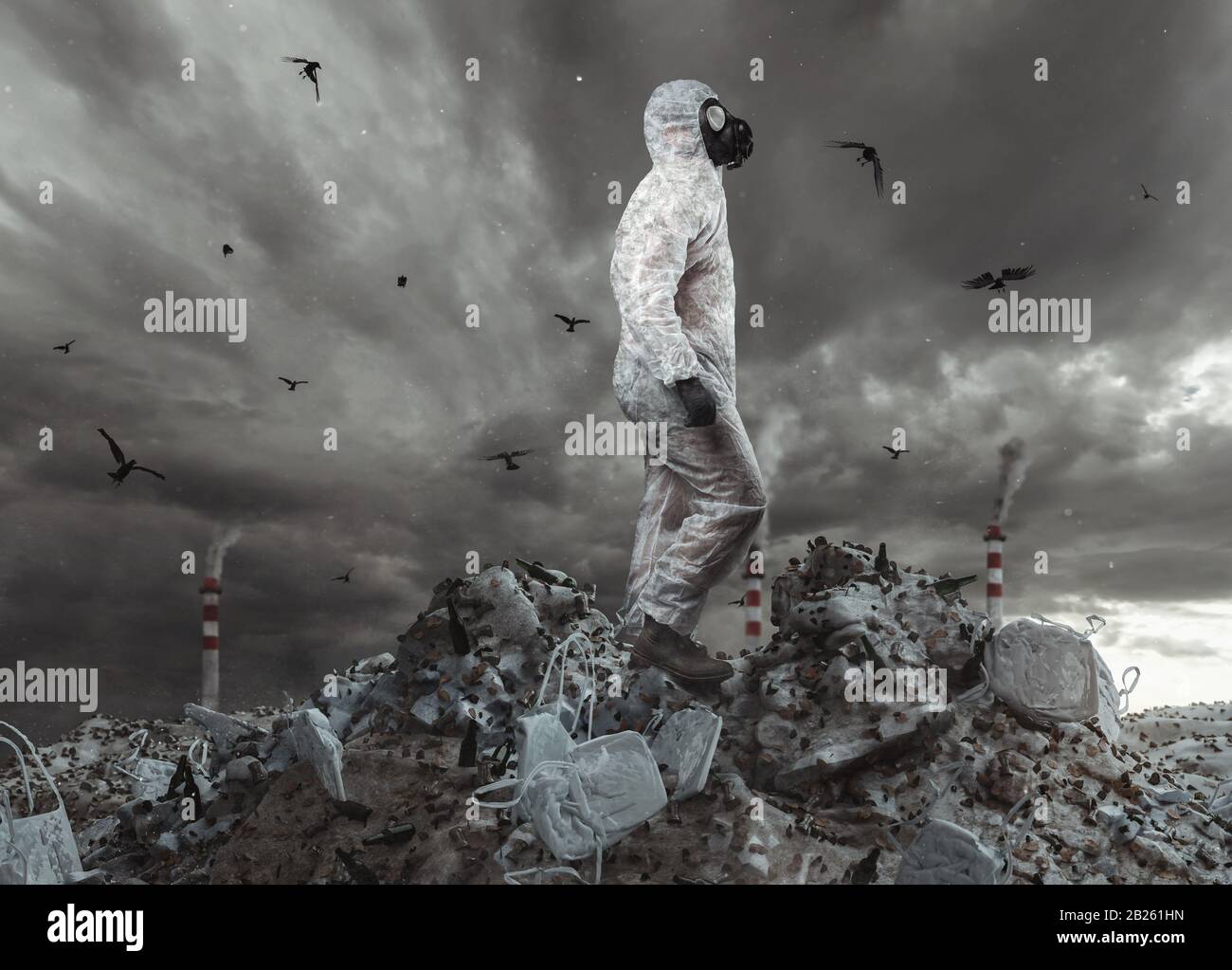 survivor with white overall and gas mask reach the top of garbage dump and watching to the apocalyptic sky Stock Photo