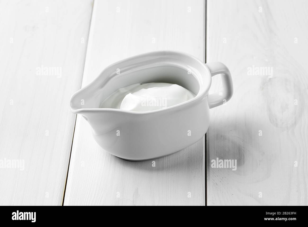 Sour cream in ceramic gravy boat Stock Photo Alamy