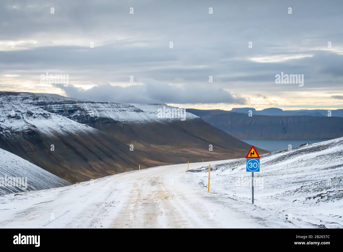 West fjords of Iceland mountain pass icy and sharp curve ahead Stock Photo