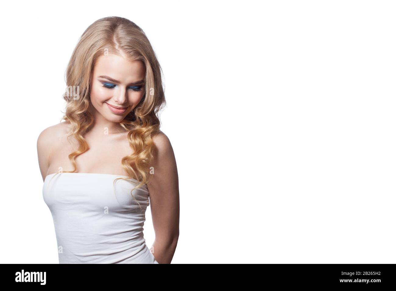 Cheerful model woman with blonde curly hairdo isolated on white ...