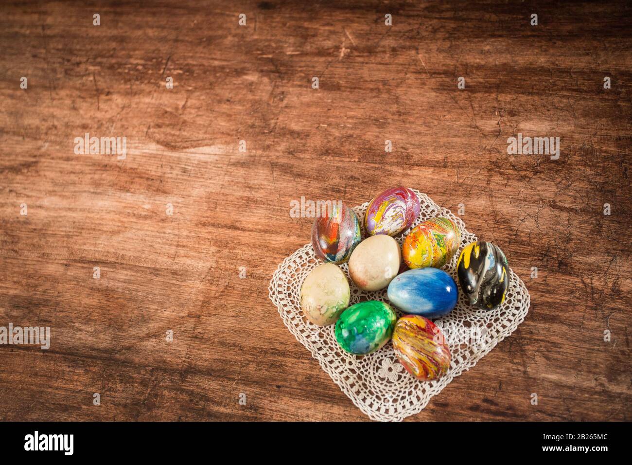Some Easter eggs in a group on the wooden background. Stock Photo