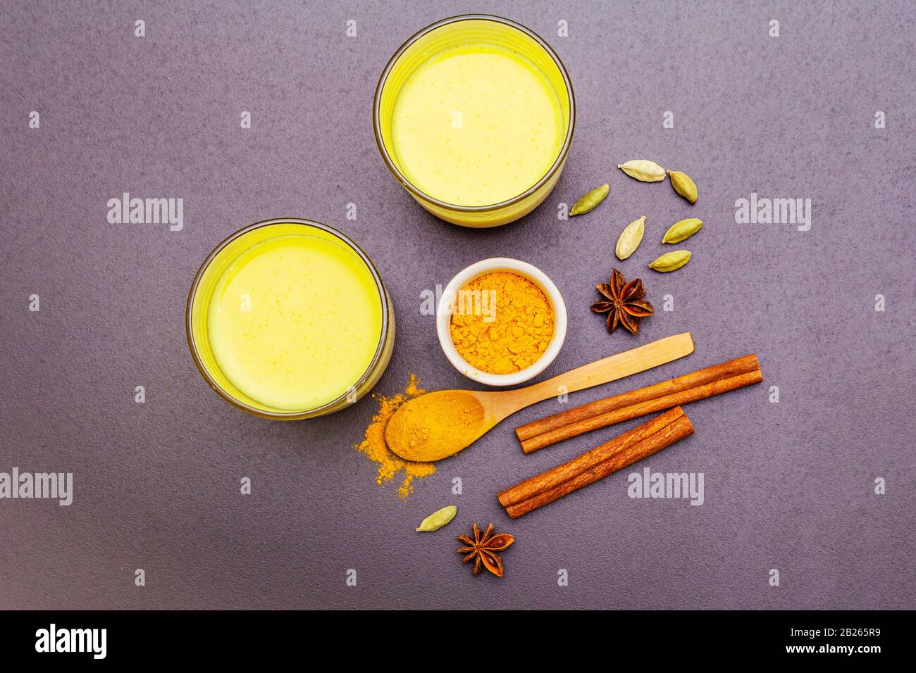 Golden turmeric milk. Cinnamon, cardamon, anise spices. Trendy healthy