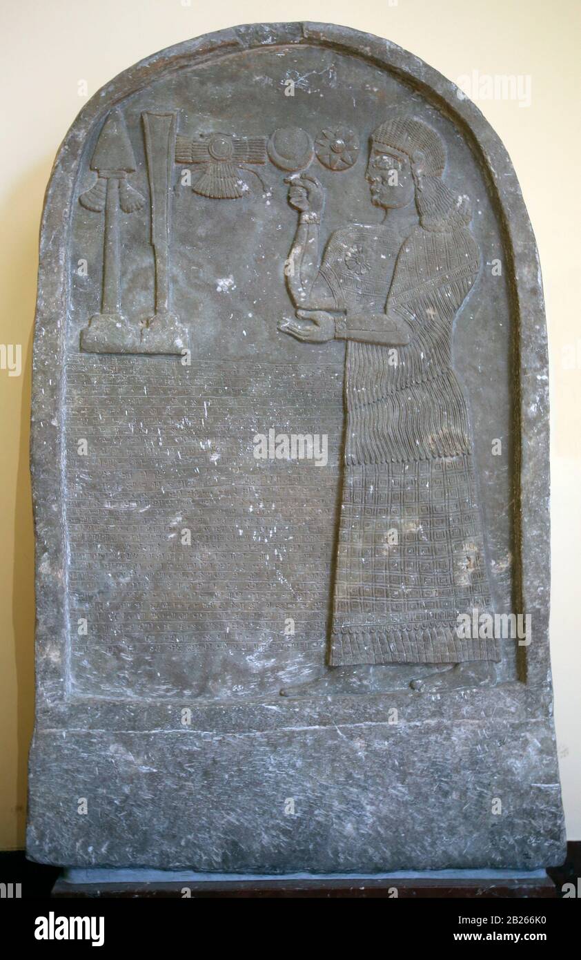 Bel-harran-beli-usur is praying in front of divine symbols. Stele with inscription and relief. 8th BCE. Limestone. Tel-Abda. Marble. Iraq. Stock Photo