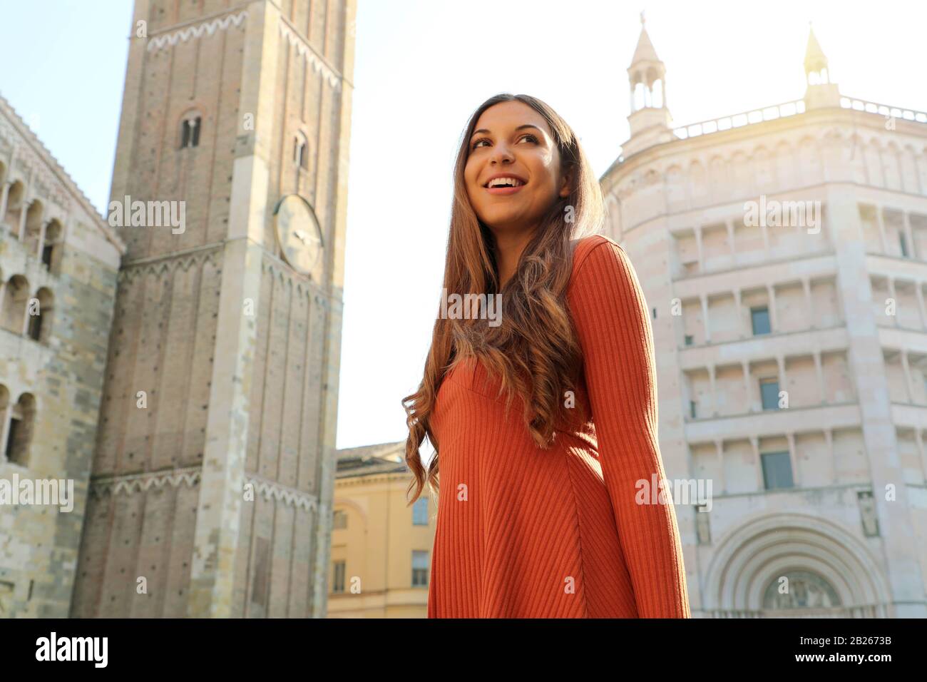 Happy beautiful woman enjoying her vacations in Italy. Smiling traveler girl enjoying her holidays in Parma, Italy. Stock Photo