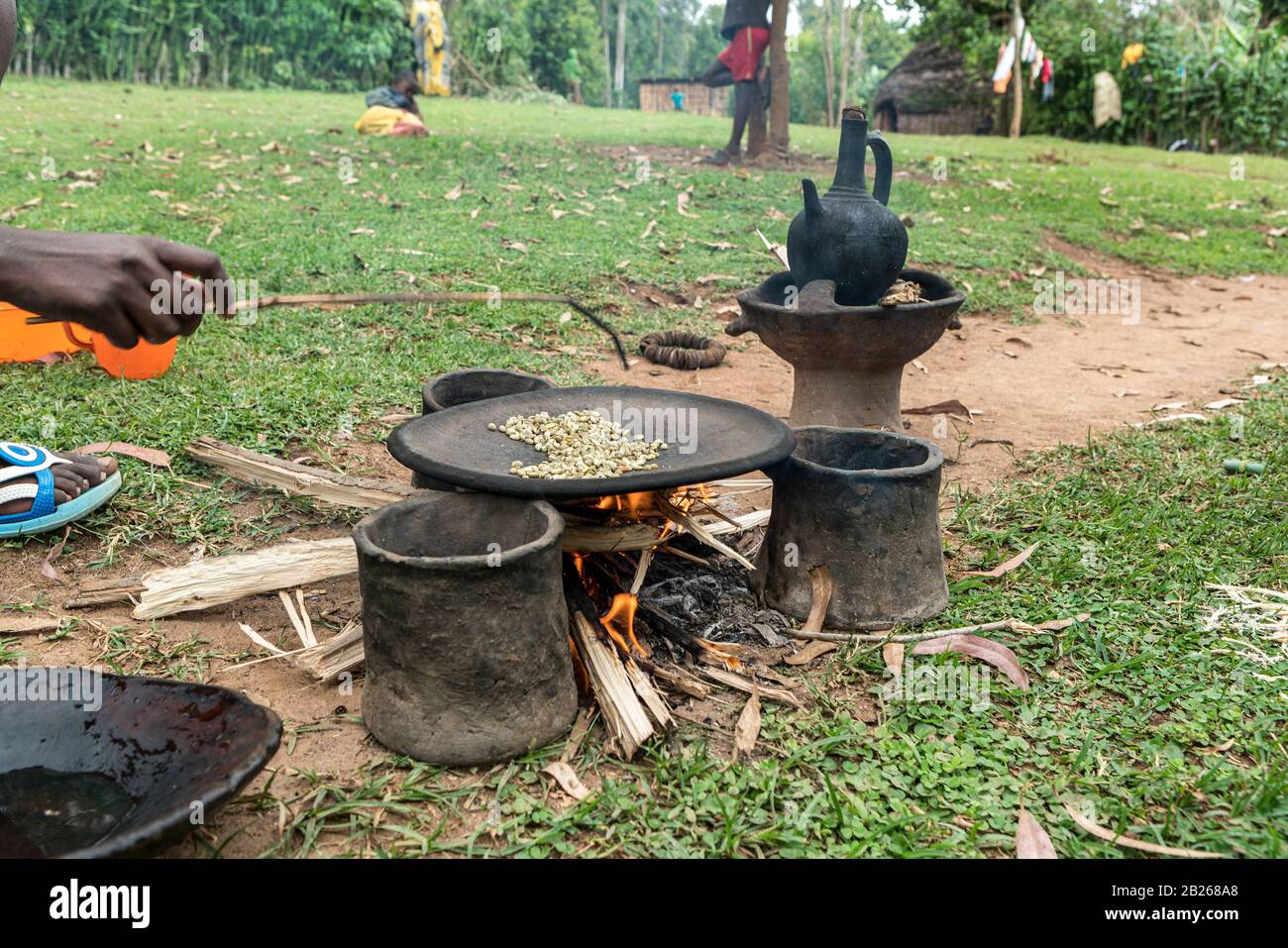 Roasting of green immature coffee beans on a flat pan in a village in southern Ethiopia Stock Photo