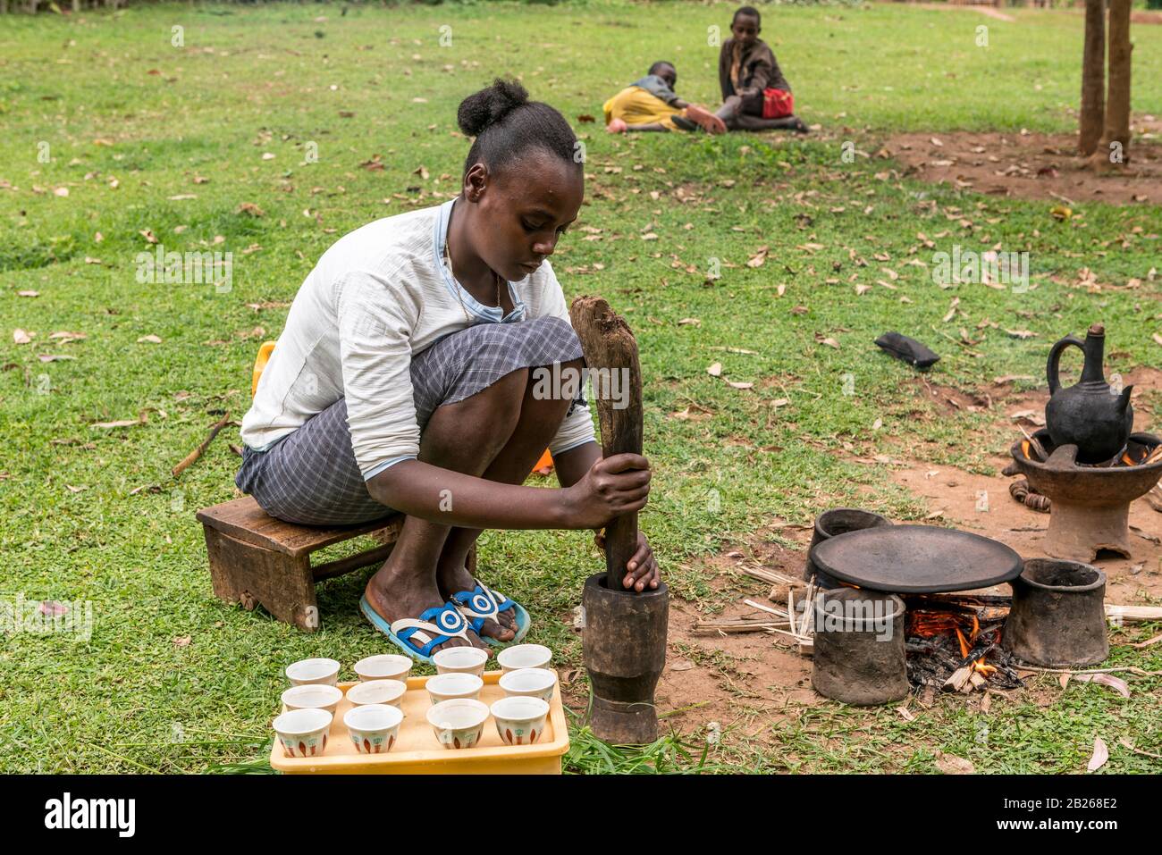 Pounding of coffee beans as part of the coffee ceremony in rural southern Ethiopia Stock Photo