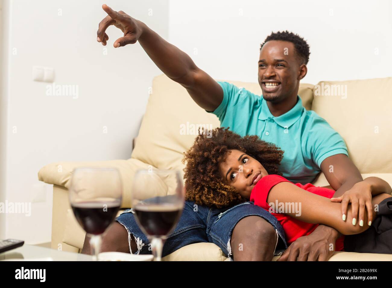 Black African American couple watching tv in the living room Stock ...