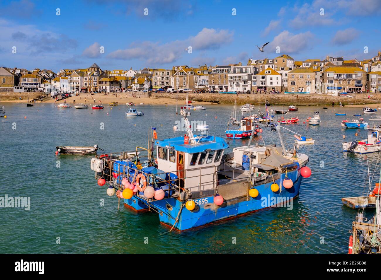 Views across St Ives Harbour to St Ives village and Smeatons Pier with boats in the Harbour, Cornwall, South West, UK Stock Photo