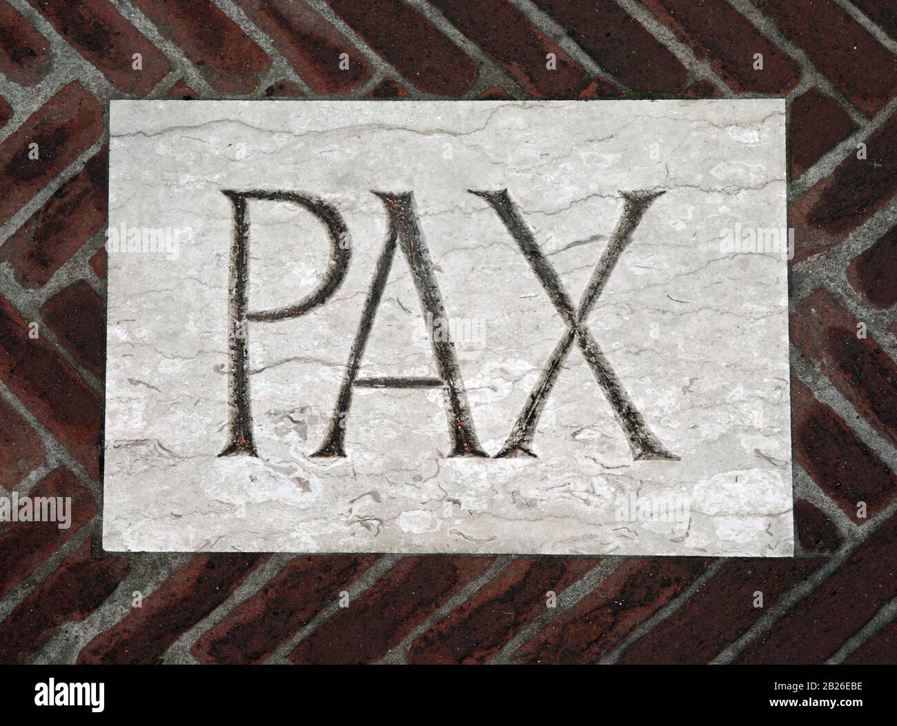 Latin writing PAX which means peace on the floor of an ancient church Stock Photo