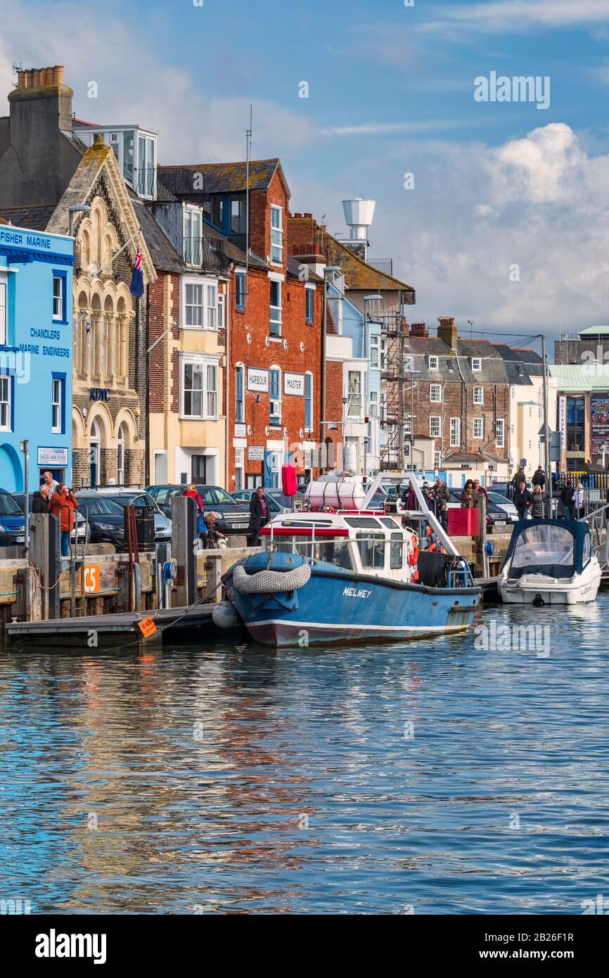 Blue boat moored in Weymouth Harbour, Weymouth Dorset, Holiday destination on the Jurassic coastline Stock Photo