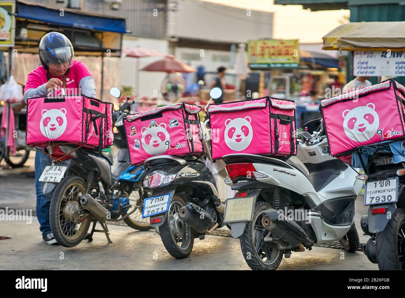 Fast food delivery service by motorcycle in Bangkok. Stock Photo