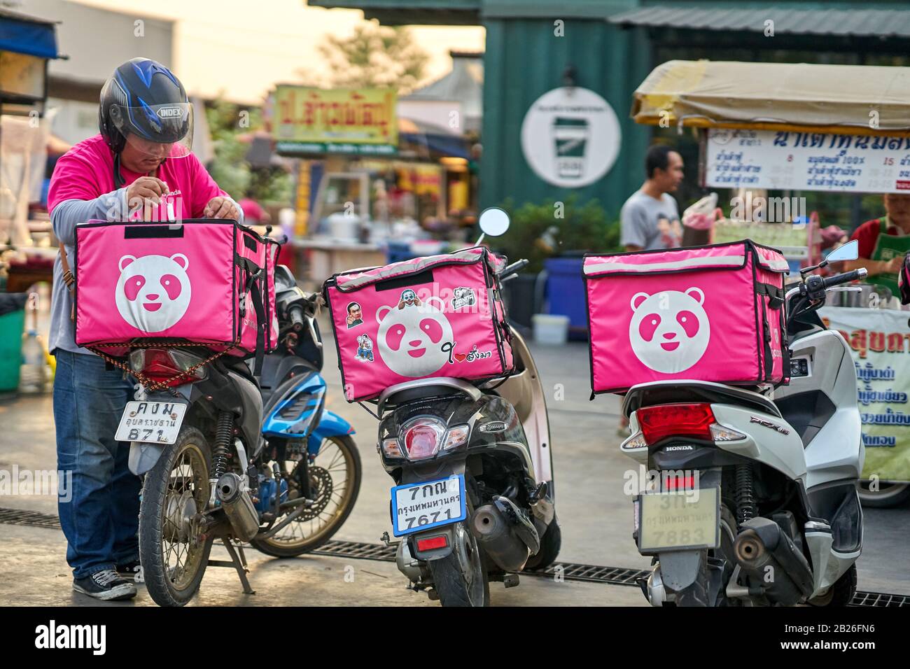 Fast food delivery service by motorcycle in Bangkok. Stock Photo