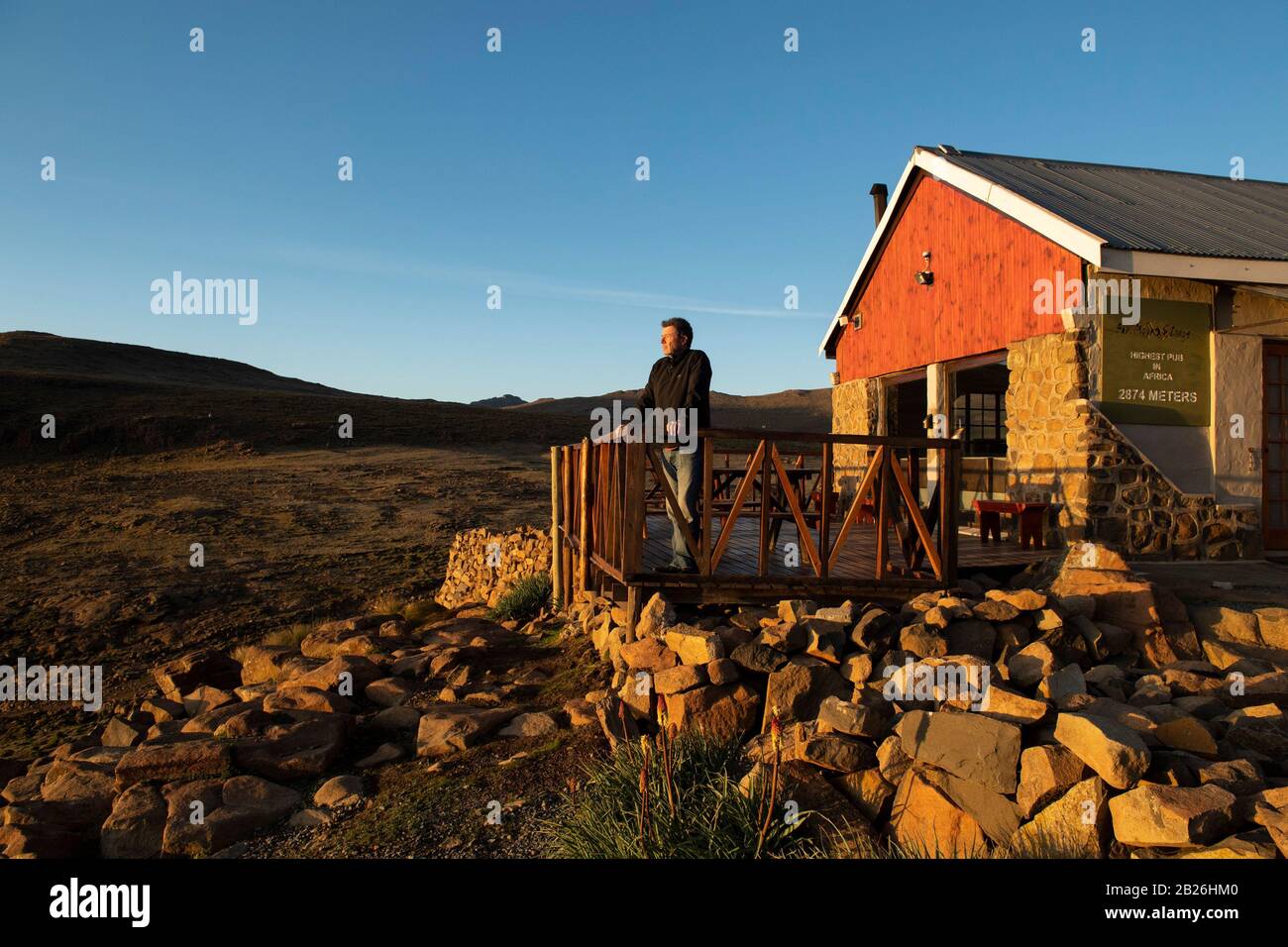 Tourist at sunrise at Sani Mountain Lodge, Lesotho Stock Photo