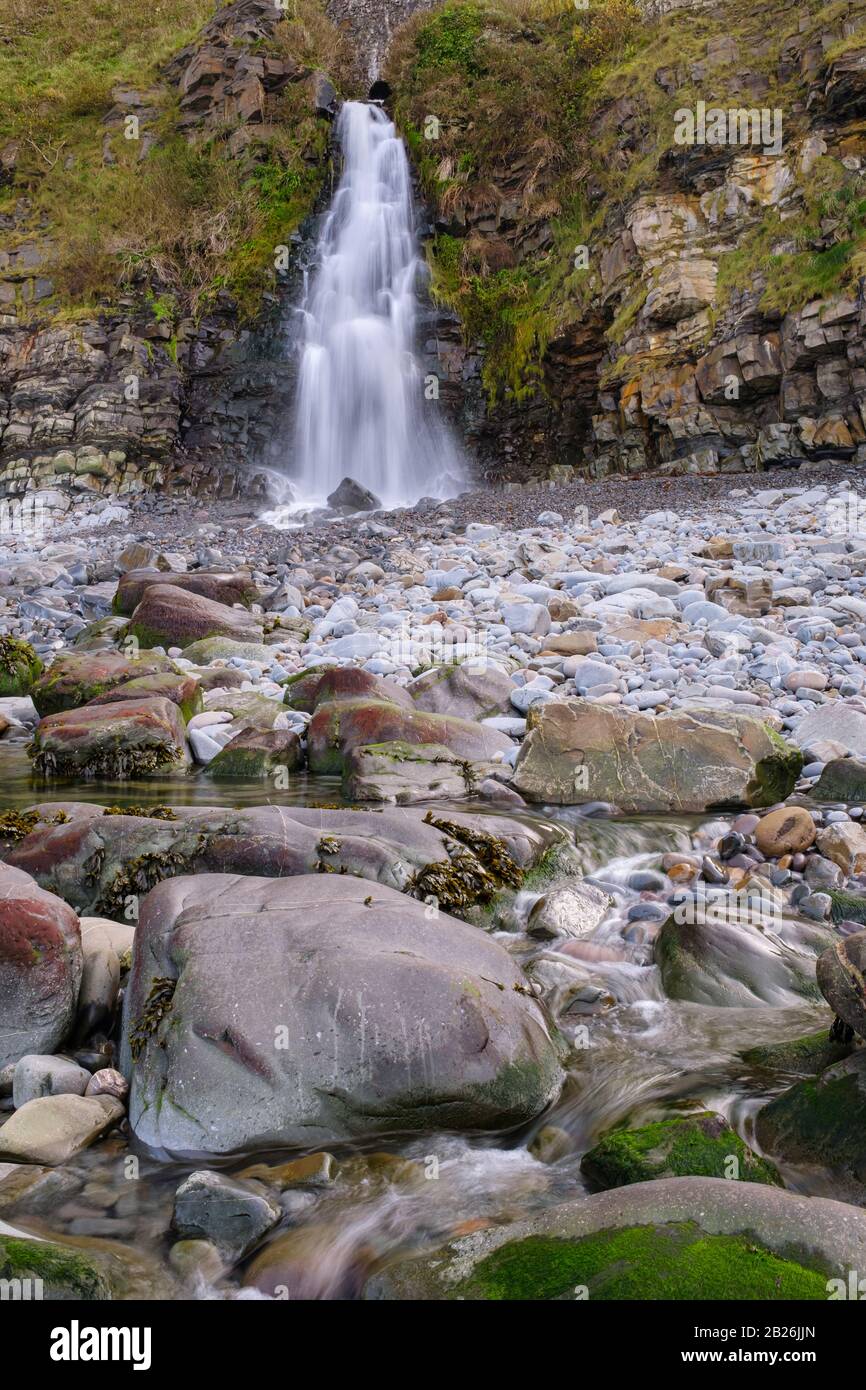 Beautiful coastal beach waterfall at the quaint village of Bucks Mills, holiday destination, beautiful North Devon, South West, Uk Stock Photo