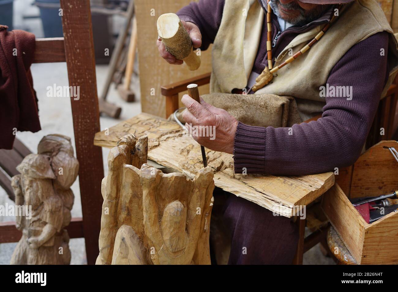 Old hands carving wood with a chisel Stock Photo