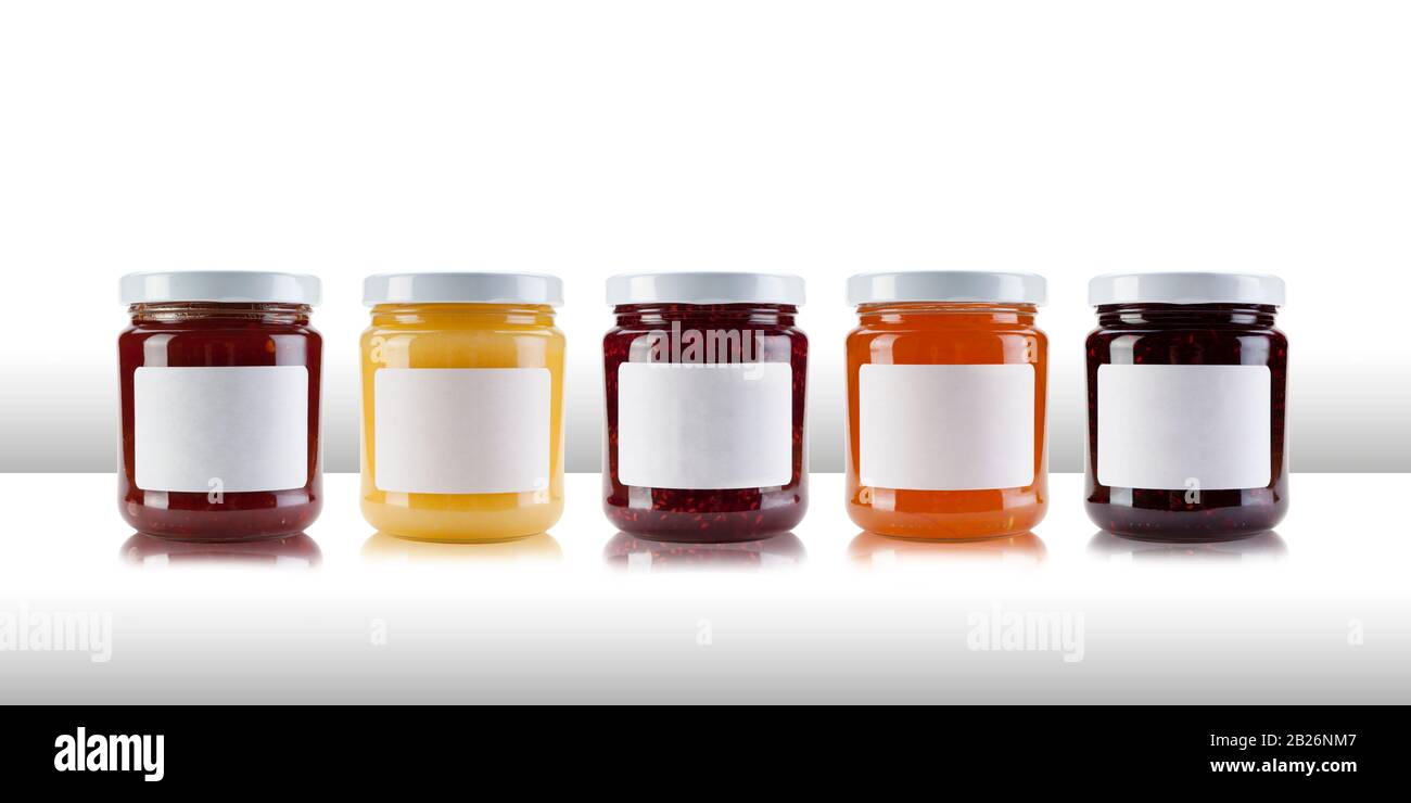 A group jars containing jams and preserves, including rasperry, strawberry,  marmalade, chutney and relish, with blank white labels on a white table li  Stock Photo - Alamy