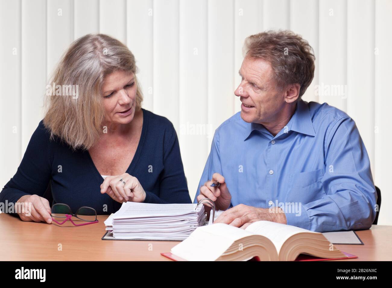 Mature woman and man discussing a project.. Could be lawyer, consultant or accoutant Stock Photo
