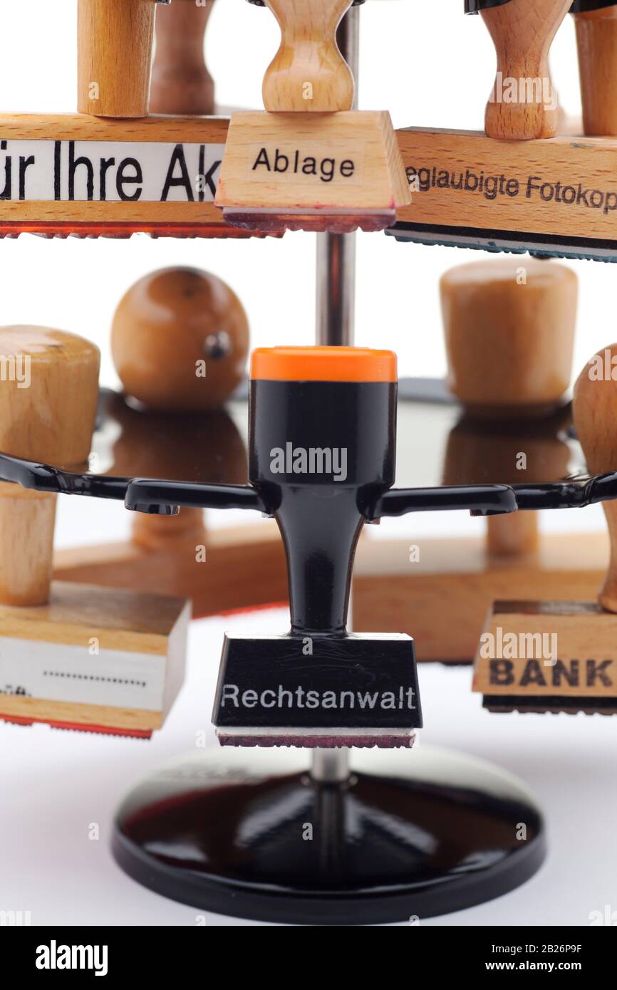 stamp holder with  stamps with the german words Rechtsanwalt - advocate, lawyer or attorney,bank - bank, Ablage - tray, Für Ihre Akten - for your file Stock Photo